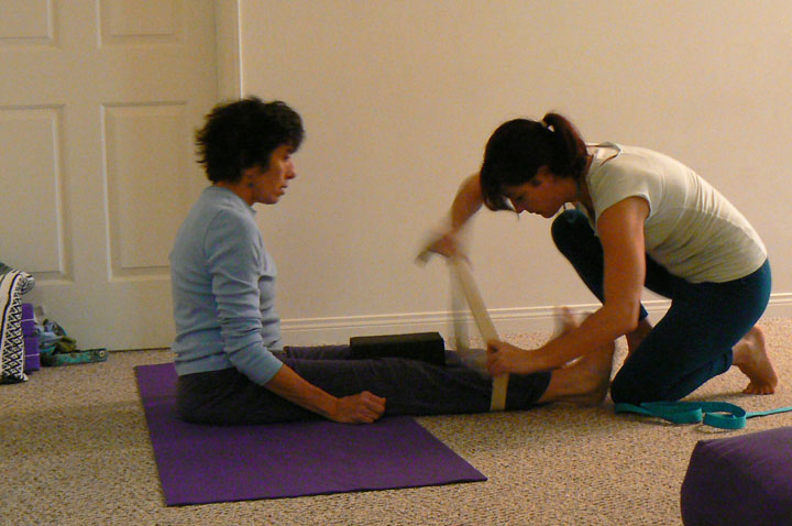 Nicole helps a student in aligning the knees.  This is good for the low back and hips!